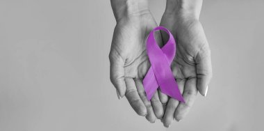 World cancer day inscription. healthcare and medicine concept - girl hands holding Purple cancer awareness ribbon clipart