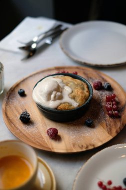 Tahtanın üzerinde dondurmayla servis edilen lezzetli tatlı çilekli tatlı. 