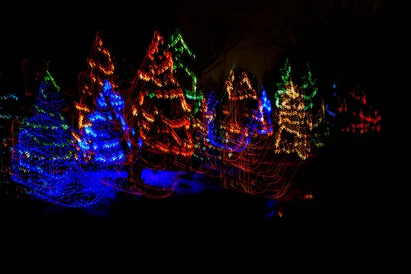 Glowing light line of Christmas trees. Abstract luminous light speed motion effect, horizontal