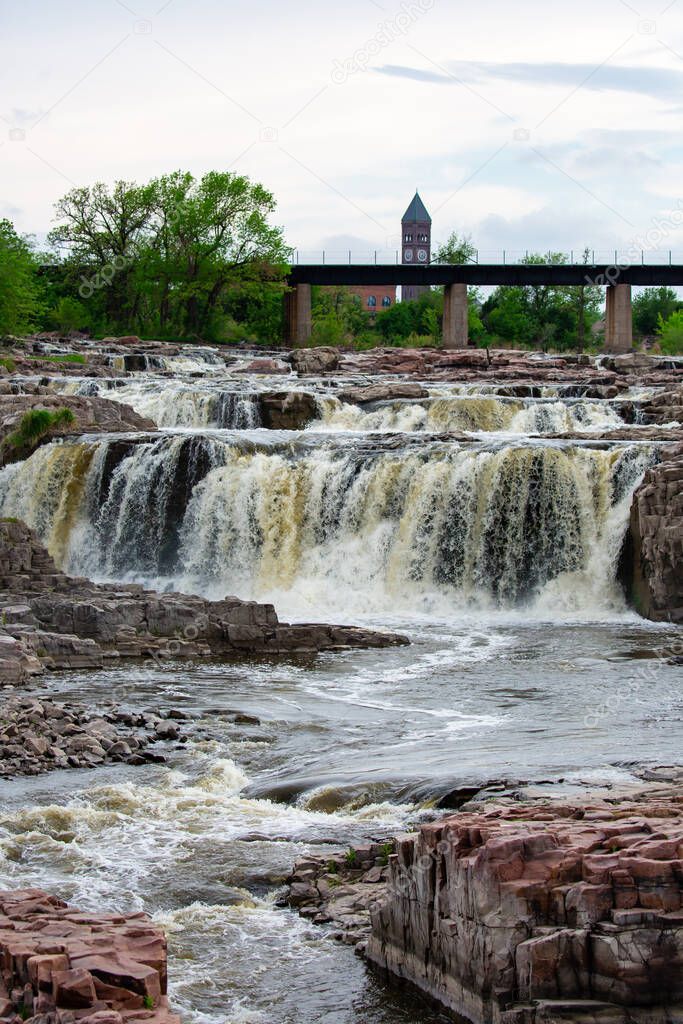 The Big Sioux River tumbles over a series of rock faces in Falls Park, Sioux City, South Dakota, vertical