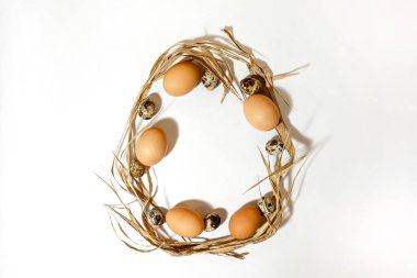 Paskalya yumurtası şekli yumurta ve samandan yapılmıştır. Minimum tatil konsepti. Düz ley, üst görünüm. .