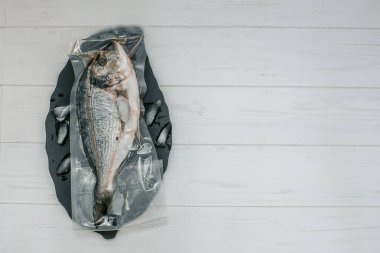 Metnin altında bir yeri olan vakum ambalajında taze balık 