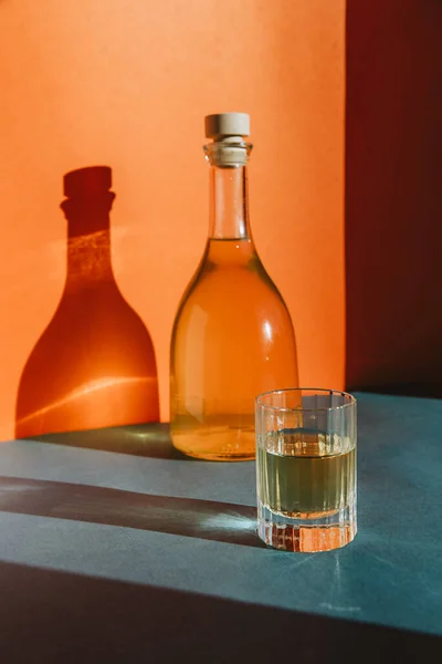 Renkli bir arka planda batan güneşin ışınlarında turuncu limonata.