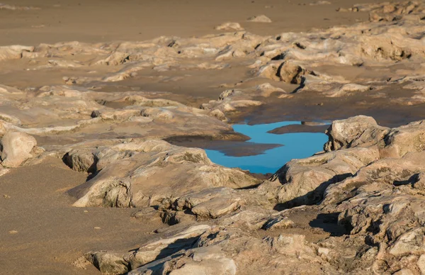 Rocky beach of Atlantic Ocean with puddle — Stock Photo, Image