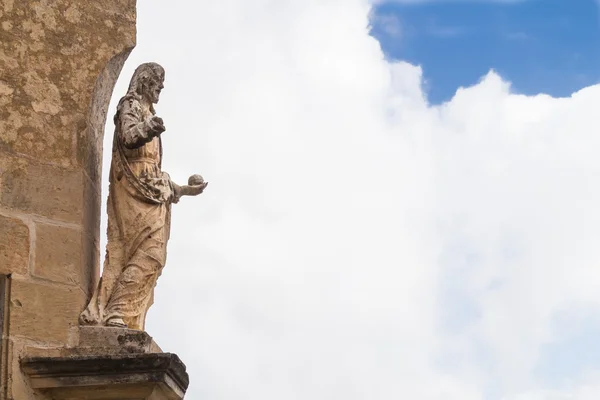 Estatua de un santo y un cielo nublado — Foto de Stock