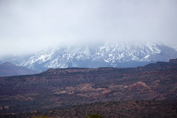 Snow on the mountains beyond the desert