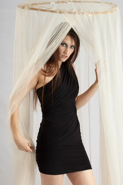 Pretty Woman Thoughtfully Playing Sheer Curtain — Stock Photo, Image