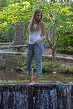 Şelalenin barajında düşünceli bir sarışın.