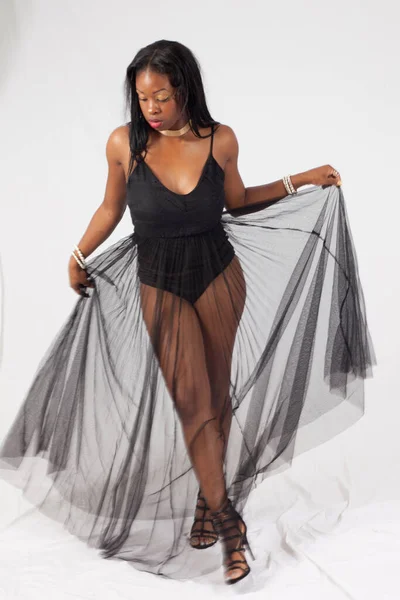 Lovely Black woman moving with a see through skirt