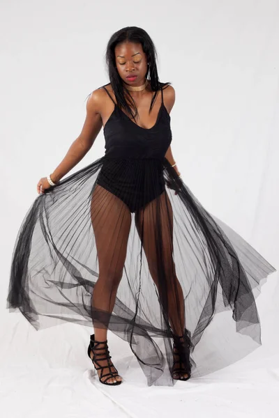 Lovely Black woman moving with a see through skirt