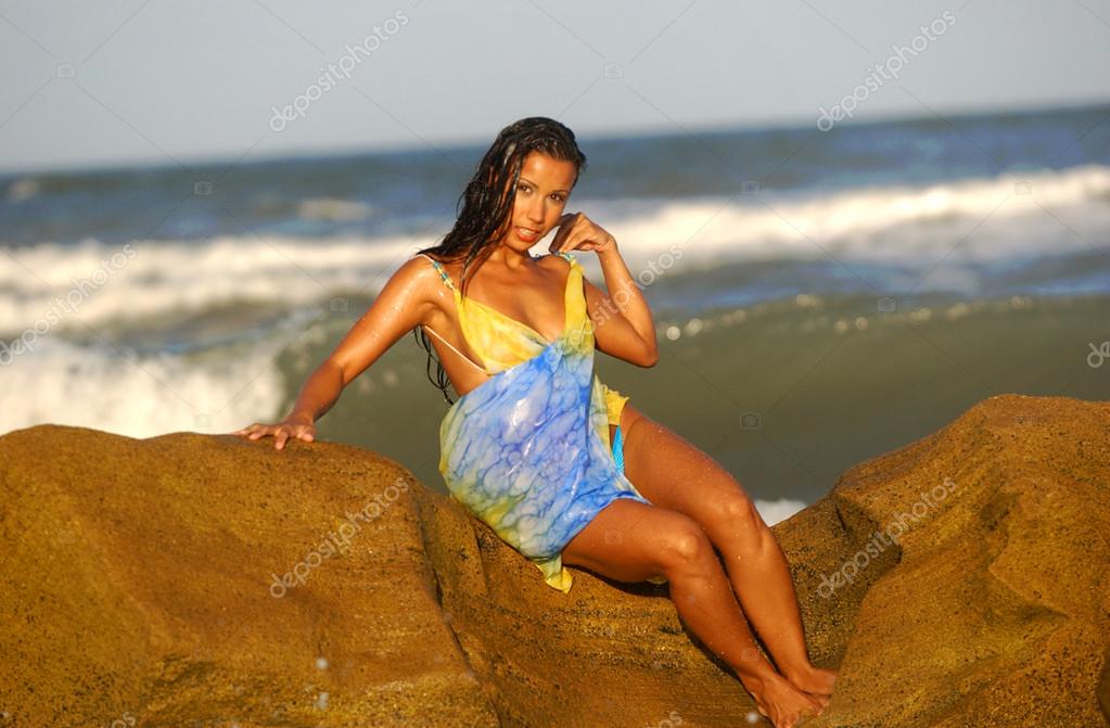 Tanned Beauty in Swimwear - Ocean Rock Background - Many Poses Stock Photo  by ©raykehoe 118447380