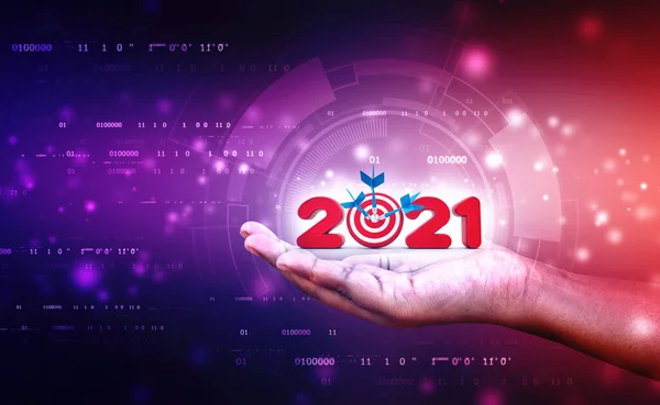 Financial and economic target or goal in 2021 year in technology background. Hand Hooding 2021 Represents the Business Success in 2021 year, 2021 with target or Goal concept