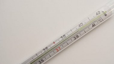 Termometre haplarla birlikte masanın üzerinde duruyor. Sıcaklık. Hastalık. Covid 19.