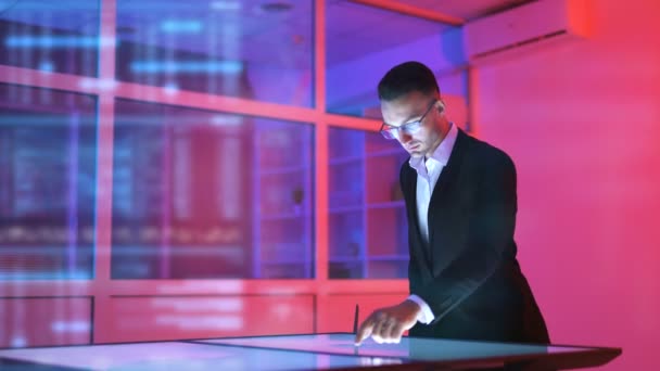 The man working with a sensor screen on the hologram background — Stock Footage Man Working Sensor Screen Hologram Background — Stock Video