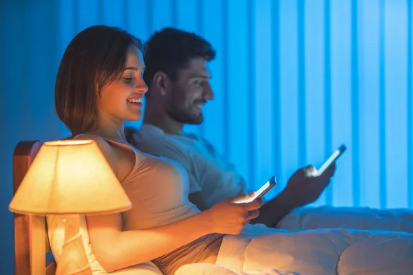 Laugh Couple Sit Bed Phone Night Time — Stock Photo, Image