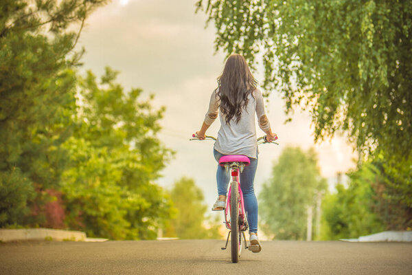 The woman riding a bike on a road