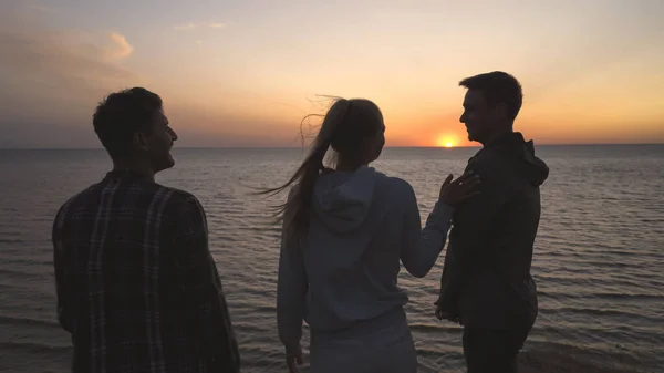 Kolme Ystävää Seisomassa Meren Rannalla Auringonlaskun Taustalla — kuvapankkivalokuva