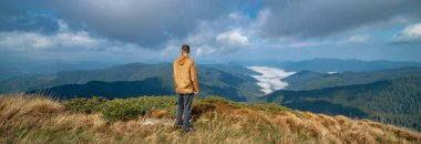 Bir dağın tepesinde duran adam.