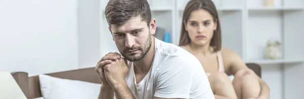 Depressieve Man Zit Naast Vrouw Het Bed — Stockfoto