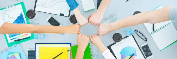 The six people gesture at the table. view from above