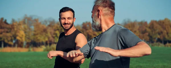 Two Sportsmen Doing Exercise Outdoor — Stock Photo, Image