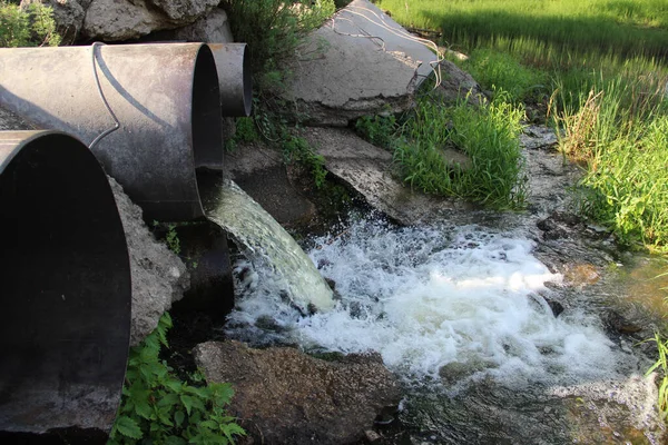 Waste water runs from the pipe contaminating the environment