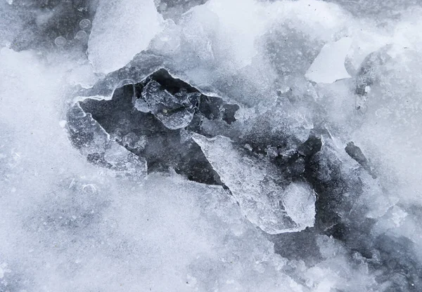 A frozen puddle with broken ice