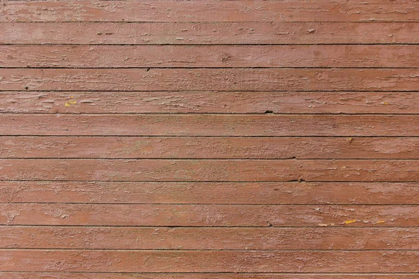 Kabuğu soyulmuş eski ahşap bir panelin dokusu birkaç kat kahverengi boya ile kaplıydı.