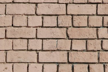 Pembeye boyanmış eski bir tuğla duvarın dokusu