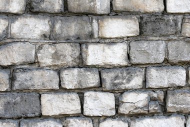 Old wall made of rough stone blocks as a background
