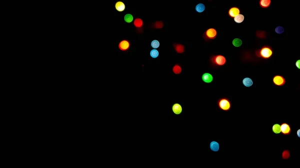 Les côtés multicolores ou boke sur fond noir. Joyeux Noël et bonne année. Fond de Noël. — Photo