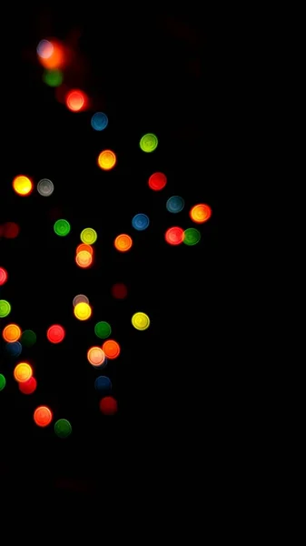 I lati multicolori o boke su uno sfondo nero. Buon Natale e felice anno nuovo. Sfondo di Natale. — Foto Stock