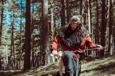 Viking cleaning his sword after a war