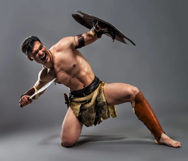 Ancient warrior. Strike with the knee — Stock Photo, Image