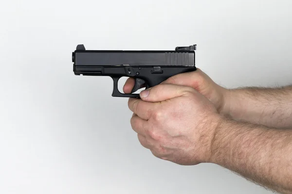 Shooter holds black handgun — Stock Photo, Image