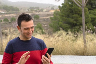 Orta yaşlı bir adam video konferansında sevgisini gösteriyor. Kavram: salgın zamanında güvenlik mesafesi.