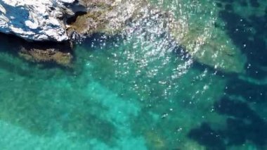 Calm Turquoise Water Reflecting Sunlight Creates a Serene Coastal View in a Tranquil Scenic Environment