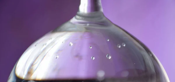 Graphic resource, background, splash screen, abstraction -gas bubbles close-up, in mineral water under glass on a lilac background.