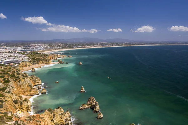Aerial view of golden coast cliffs of portuguese southern beaches in Lagos City, Algarve, Portugal. Camilo beach.Aerial view of golden coast cliffs of portuguese southern beaches in Lagos City, Algarve, Portugal. Camilo beach and Ponta da Piedade.