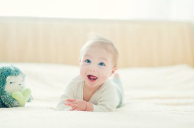 Yatakta oynayan neşeli çocuk..