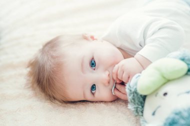 Yatakta oynayan neşeli çocuk..