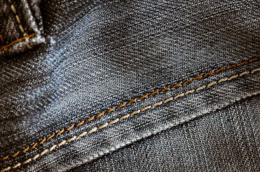 Kot pantolon arka planını ve kumaşı kapat. Kot giyim etiketi etiketi, kilitler.