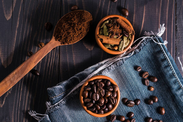 Coffee beans whole and ground on the table.