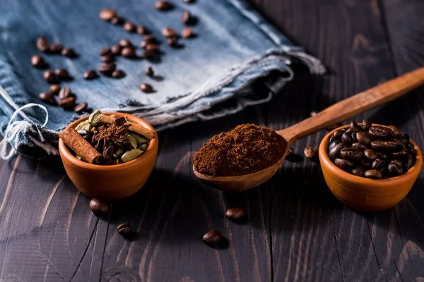 Coffee beans whole and ground on the table.