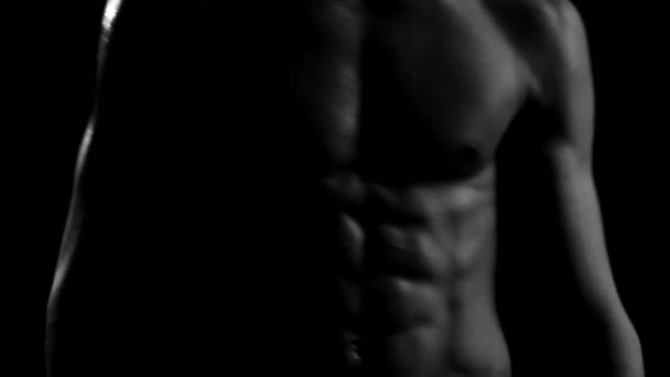 Perfect naked male torso muscles moving in the darkness close up — Stock Video