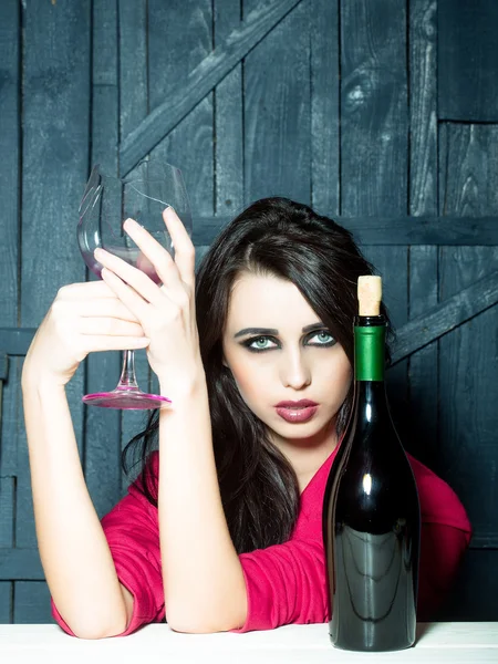 Thoughtful woman with bottle — Stock Photo, Image