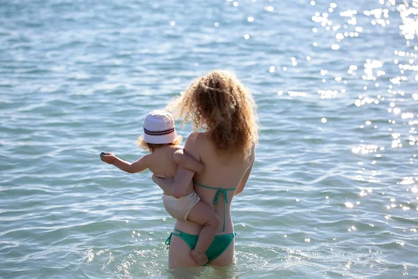 Woman in bikini with child