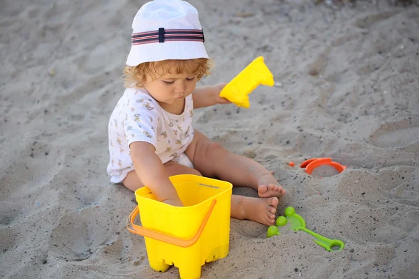 Boy plating with plastic toys Royalty Free Stock Images