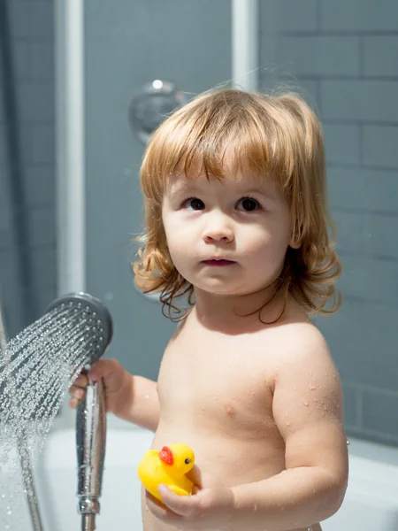 Boy with duckling in bath — Stock Photo, Image