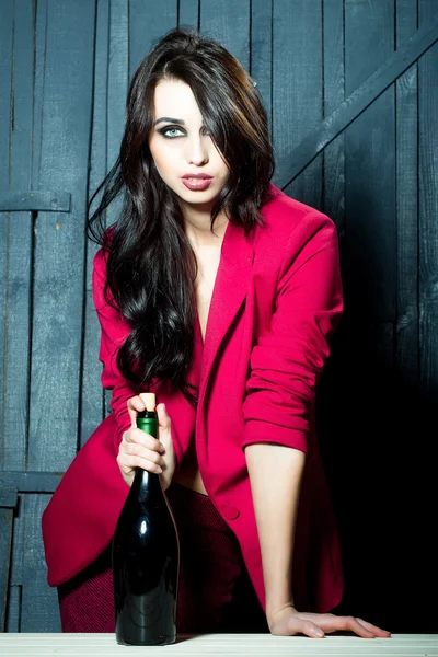 Stylish woman with bottle — Stock Photo, Image